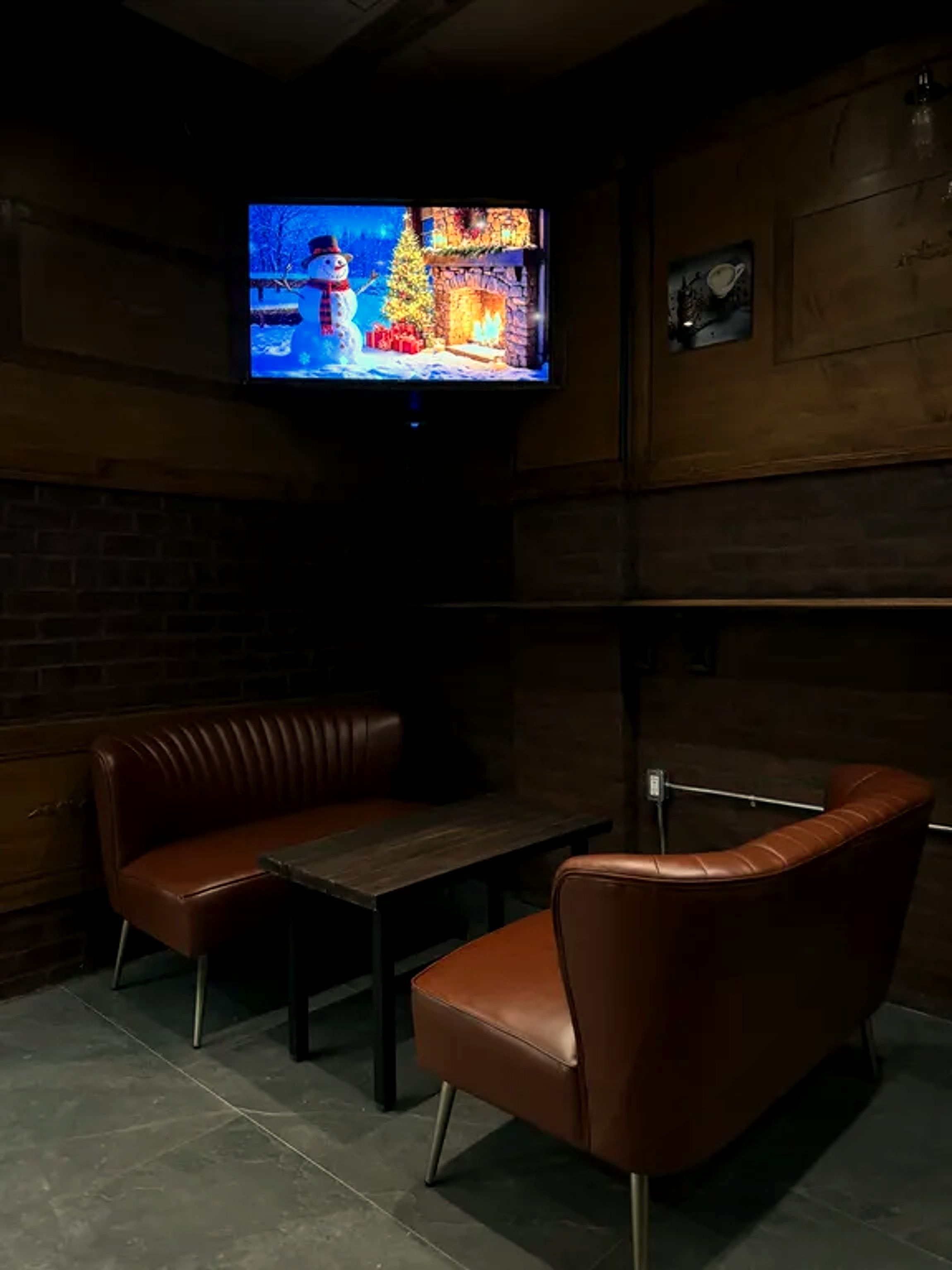 Cozy seating with a screen for game days at One Gram Coffee Bar