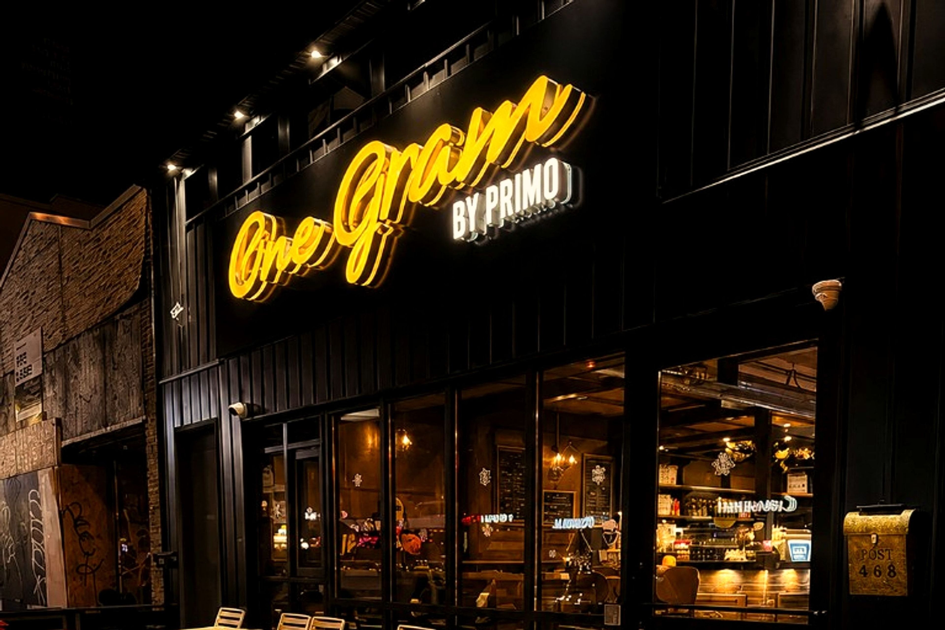 Nighttime exterior of One Gram Coffee Bar on Danforth Avenue